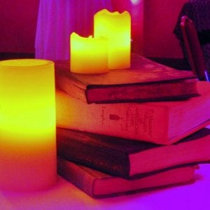 Cocktail tables with aged books and candles